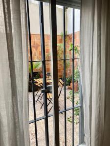an open window with a view of a patio at La Vega Rooms in Huelva