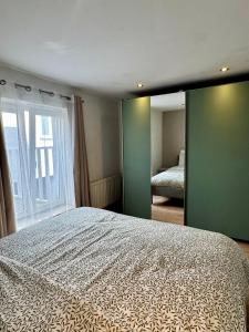 a bedroom with a bed and a large window at Yamohome in Brussels +5 photos