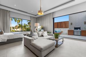 a living room with a couch and a bed at Peaceful Retreat with Pool – Ideal for Relaxation in Cruz de Huanacaxtle