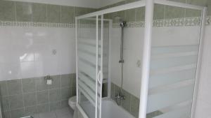 a shower with a glass door in a bathroom at Hôtel du Square d'Anvers in Paris