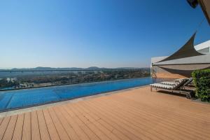 a balcony with a view of a swimming pool at 423 Menlyn maine Apartment in Pretoria