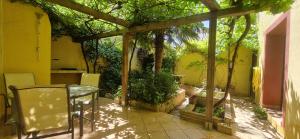a patio with a table and trees and a building at Casa Rural Altozano de Buendia in Buendía