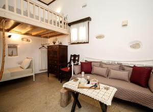 a living room with a couch and a table at Imellos in Apeiranthos