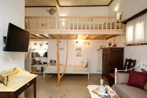 a living room with a loft bed and a couch at Imellos in Apeiranthos