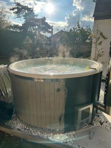 a hot tub in the backyard with smoke coming out of it at Island Retreat with HotTub in West Mersea