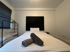 a bedroom with a bed with a towel on it at 2 Bedroom flat by London Bridge & The Shard in London
