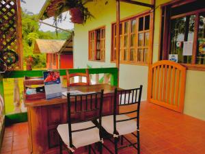 a wooden table and chairs in a room at Puerto Quito Lodge - Las Iguanas in Puerto Quito
