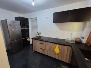 a kitchen with a refrigerator and a counter top at Sensalys in Sainte-Rose