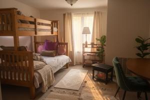 a bedroom with a bunk bed and a couch at Blue Bird Chalet 5BR with Sauna near Skiing in East Chatham +17 photos