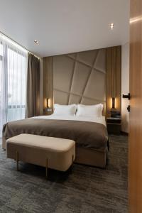 a hotel room with a large bed and a large window at Silver Apart in Truskavets +59 photos