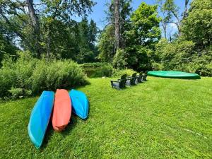 a row of kayaks lined up on the grass at Historic Canal Home on Nature Preserve in Heathcote