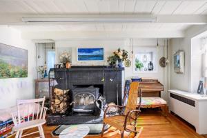 a living room with a fireplace and a desk at Charming & Whimsical Historic River Home in Titusville