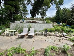 a patio with chairs and a table and a bench at Charming & Whimsical Historic River Home in Titusville