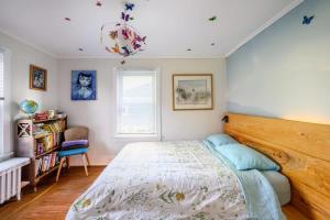 a bedroom with a large bed and a chandelier at Charming & Whimsical Historic River Home in Titusville +81 photos