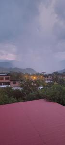 a red paved road with lights in a city at Casa San Ramón in San Ramón