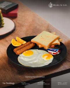 a plate of breakfast food with eggs sausage and orange slices at Portia Beach Grand in Hulhumale +7 photos