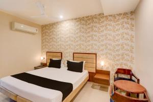 Ένα ή περισσότερα κρεβάτια σε δωμάτιο στο Hotel O GSP Grand