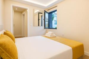 a bedroom with a white bed and a window at JoLi Larano - 3 Bedrooms & 2 WC Exclusive in Machico +44 photos