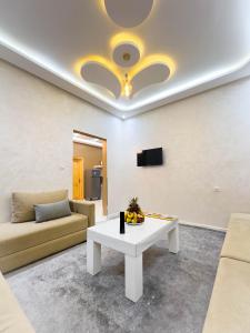 a living room with a couch and a table at Hotel America Apartments in Dakhla