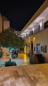 a courtyard with a tree in the middle of a building at Derin park otel in Sanlıurfa