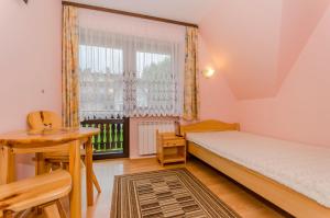 Posteľ alebo postele v izbe v ubytovaní Pokoje Apartamenty Pod Limbą