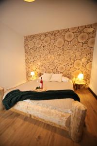 a bedroom with a large bed with a table on it at Rochowa Buźnica Apartament 1 in Zakopane +7 photos