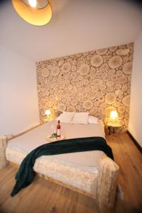 a bedroom with a large bed with a wall at Rochowa Buźnica Apartament 1 in Zakopane