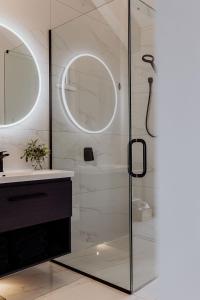 a bathroom with a glass shower and a sink at The Black Barn - Panoramic, Private & Luxury in Marsden +28 photos