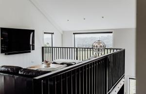 a living room with a couch and a large window at The Black Barn - Panoramic, Private & Luxury in Marsden