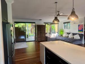 a kitchen and living room with a couch and a table at The Hinterland Spa & Moon Retreat in Boyland +80 photos