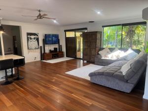 a living room with a couch and a piano at The Hinterland Spa & Moon Retreat in Boyland