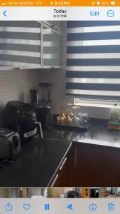 a kitchen with a sink and a counter top at The Manor in Ikoyi