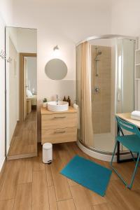 a bathroom with a shower and a sink and a mirror at Europe Station House in Parma