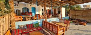 a patio with chairs and a table and a table and chairs at Blue Door in Aswan