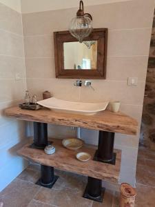 a bathroom with a sink and a mirror at L'envol des papillons in Lafarre