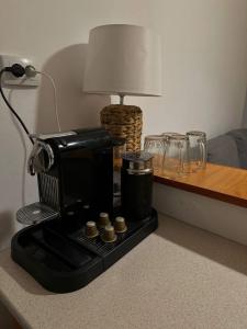 una cafetera sentada en una mesa con una lámpara en Studio Central Ro1, en Râmnicu Vâlcea