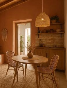 a dining room with a table and two chairs at Katoi suite in Éxo Khóra +24 photos