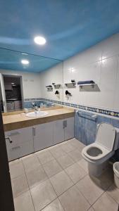 a bathroom with a toilet and a sink at Casa Galena in Corralejo +23 photos