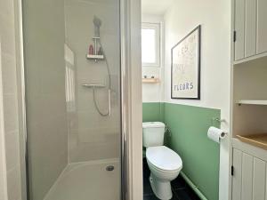 a small bathroom with a toilet and a shower at Le Coignebert in Rouen +10 photos