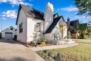 a white house with a black roof at The Brass Tulip in Tulsa