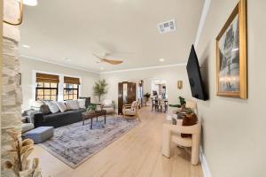 a living room with a couch and a table at The Brass Tulip in Tulsa