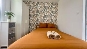 a bedroom with a bed with towels on it at Le Coignebert in Rouen