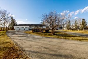a house on the side of a road at Acreage, 3 King Beds and Ensuites, Dance Floor, Fireplace, AC in Calgary