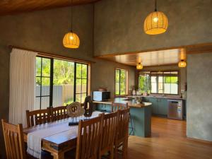a kitchen and dining room with a table and chairs at Stillwater Residence - Lakeview Serenity Retreat in Ngongotaha +15 photos