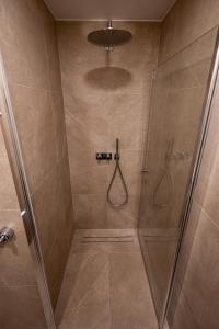a bathroom with a shower with a glass door at Vytauto 12 in Marijampolė +2 photos