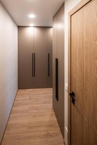 a hallway withjar doors and a wooden floor at Vytauto 12 in Marijampolė