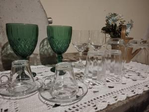 a table with glasses and wine glasses on it at Refúgio Estação in Guararema