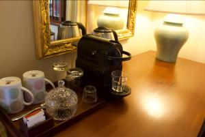 a table with a coffee maker and cups and a mirror at Petit Paradis Hiriketiya in Hiriketiya +40 photos