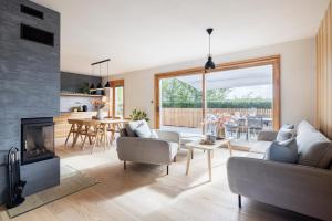 een woonkamer met een bank en een open haard bij Chata Modřínka apartmány in Seč