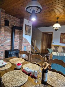 a living room with a table and a wood stove at Hereczówka in Laskówka